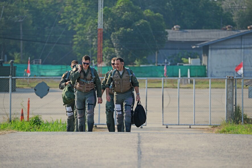 F-15C Eagle pilots from the 44th Fighter Squadron, Kadena Air Base, Japan, “step” to their aircraft during COPE TIGER 2018 at Korat Air Base, Thailand, March 20, 2018.