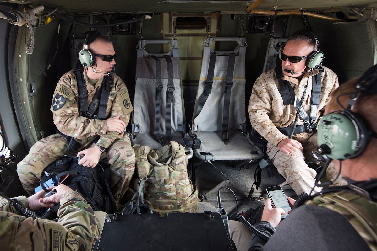 Joint Chiefs chairman and his senior enlisted advisor talk aboard a helicopter flying over Afghanistan.