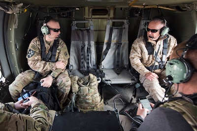 Joint Chiefs chairman and his senior enlisted advisor talk aboard a helicopter flying over Afghanistan.