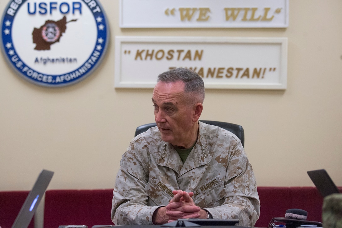 Marine Corps Gen. Joe Dunford, chairman of the Joint Chiefs of Staff, sits at a table.