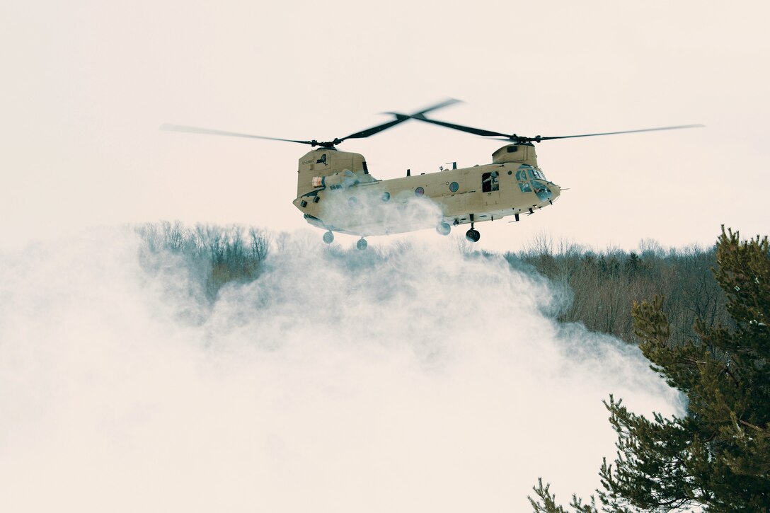 A helicopter prepares to land and insert soldiers.