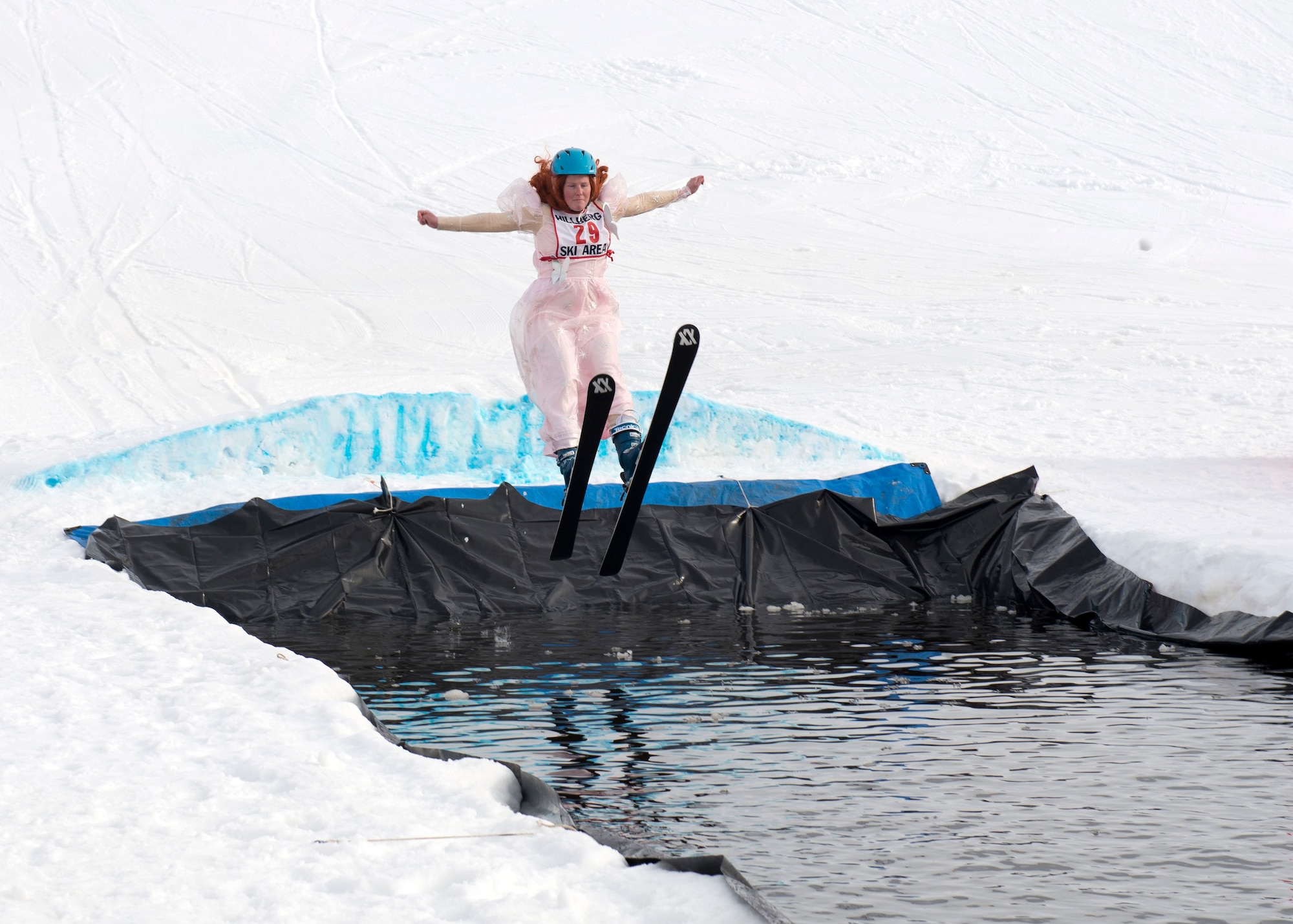 Laura Long, a participant of the 2018 Slush Cup, skis into the slush pond at Joint Base Elmendorf-Richardson’s Hillberg Ski Area, March 18, 2018. The Slush Cup is a two-fold annual event celebrating the change in weather, consisting of skiers and snowboarders trying to make it across a man-made slush pond without falling.