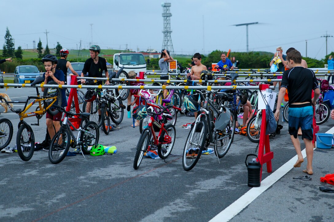 Participants quickly transition from the swim to bike portion of the 7th Annual TriKids and Women’s Only Triathlon March 17 aboard Camp Courtney, Okinawa, Japan. The triathlon tested the participant’s abilities in the swimming, biking and running events. Participants had to complete a 50-meter swim, transition to a 2-kilometer bike route and finish with a 1-km run. (U.S. Marine Corps photo by Pfc. Nicole Rogge)