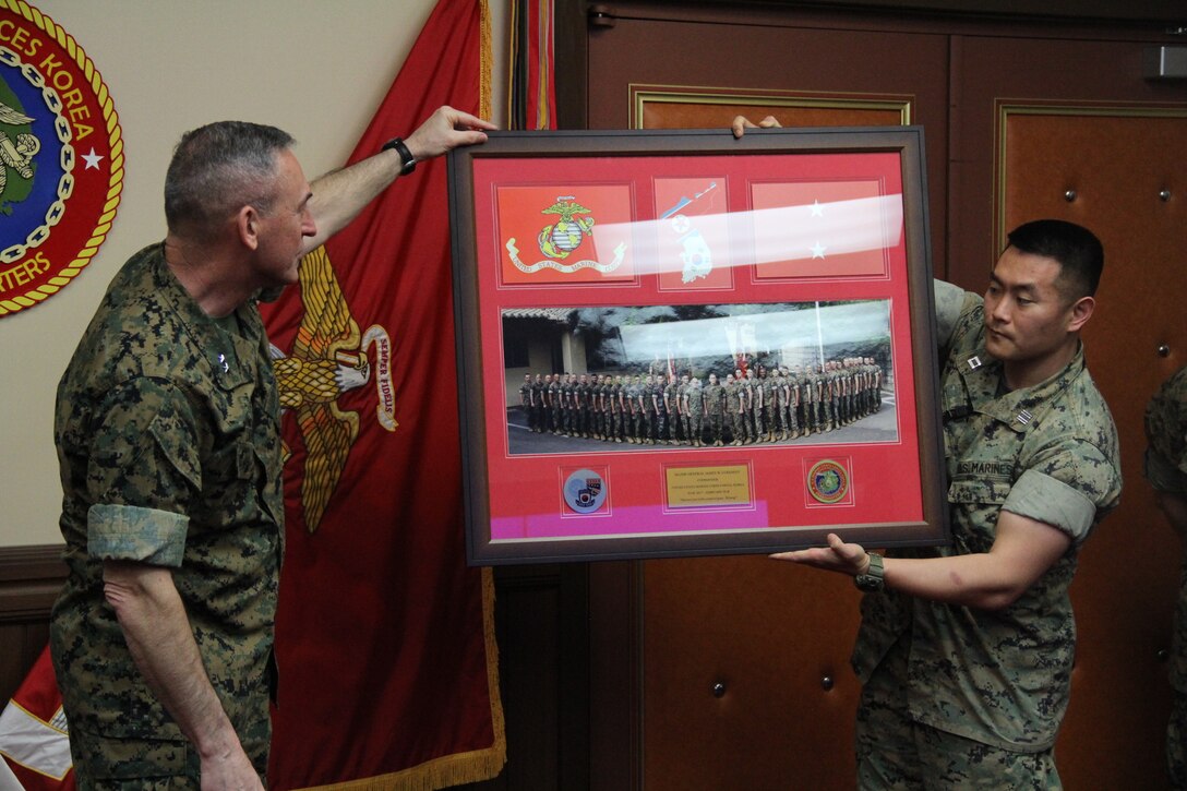 Maj. Gen. James W. Lukeman (left), assistant chief of staff of Plans and Policy for United Nations Command, Combined Forces Command, and U.S. Forces Korea, admires his post-command gift presented by the Marines of U.S. Marine Corps Forces Korea here, March 15.  Maj. Gen. Patrick J. Hermesmann took command of MARFORK following a change of command ceremony with Lukeman, Feb. 9, 2018. (Official U.S. Marine Corps Photo by Sgt. Nathaniel Hanscom/Released)