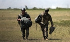 U.S. Soldiers, both assigned to Company H, 121st Infantry Regiment (Airbourne) (Long Range Survaliance Company), Georgia National Guard, navigate themselves to the meet-up point