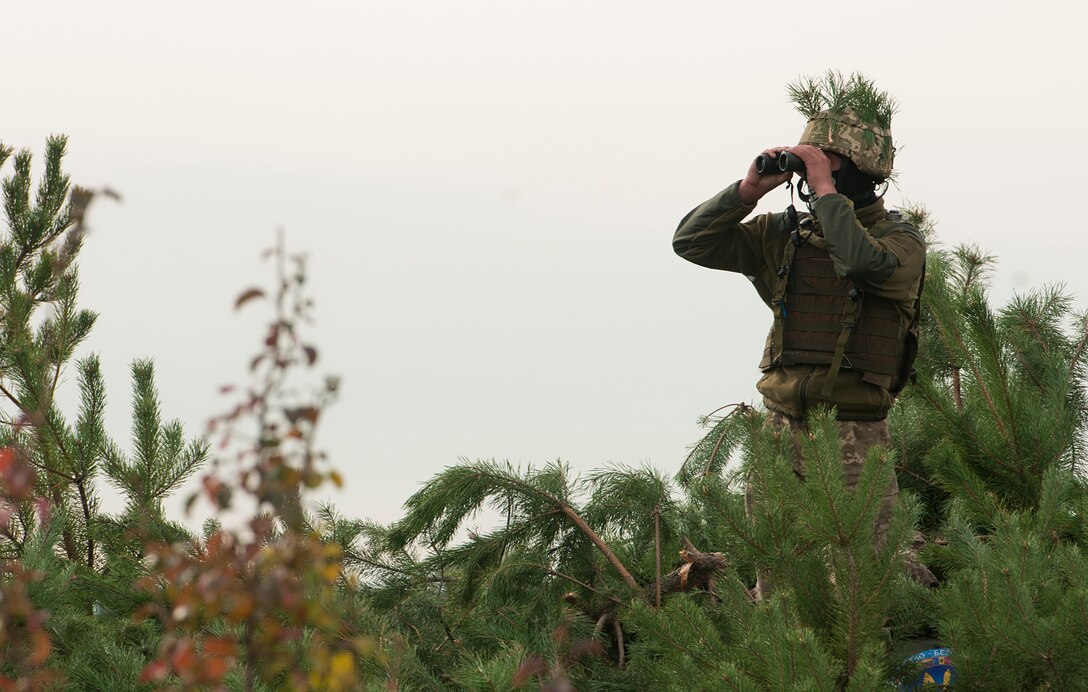 A Ukrainian soldier with the 1st Mechanized Battalion, 30th Mechanized Brigade scan his sectors