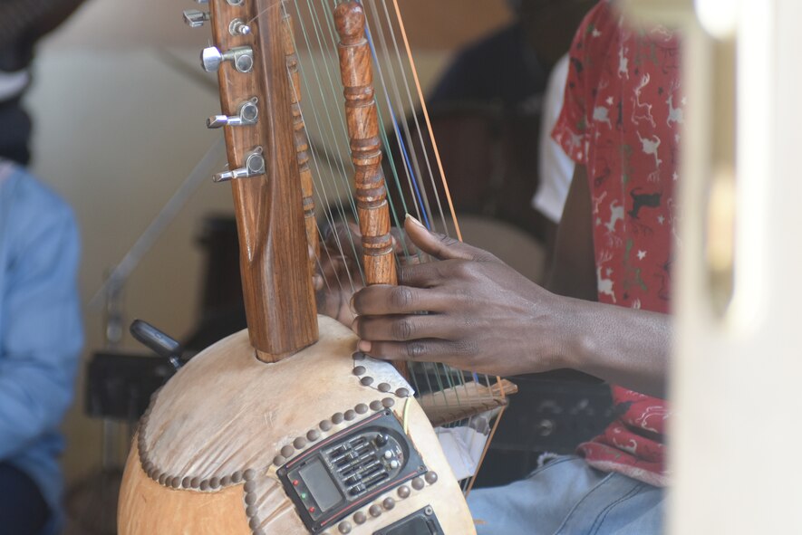 A student plays the kora at the National School of the Arts in Dakar, Senegal, March 21, 2018. The student performed for an audience of fellow students and the U.S. Air Forces in Europe Band, who are in Dakar to support African Partnership Flight Senegal, a military-to-military event focusing on improving professional military aviation knowledge and skills. (U.S. Air Force photo by Airman 1st Class Eli Chevalier)