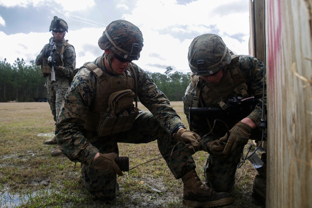 U.S. Marines from different units arm a breaching charge during an urban breaching range at Camp Lejeune, N.C., March 20, 2018. Marines performed urban breaching exercises to gain hands-on experience in conducting tactical maneuvers, as well as proper handling and making of explosive charges. The Marines are with 2nd Combat Engineer Battalion and 3rd Battalion, 6th Marine Regiment, 2nd Marine Division.