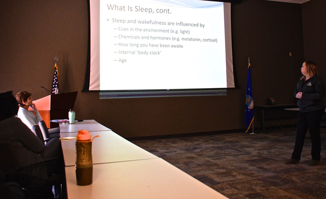 Caitlin Murphy, Civilian Health Promotion Specialist, teaches a healthy living course on how to get more restful sleep on March 21, 2018, at Scott Air Force Base, Ill.  The class explained dangers of lack of sleep when driving and operating equipment, along with how to prepare for a good night's sleep.  Looking on is Stephanie Boehning, the 932nd Airlift Wing Process Manager and Certified Covey facilitator.  Boehning, helps facilitate improvement courses like this, which are all listed on the wing's EIM page.  Electronic mail reminders are sent to unit members to give them a chance to come and not only improve themselves personally, but also improve the execution of their unit, squadron, group and wing mission.  (U.S. Air Force photo by Lt. Col. Stan Paregien)