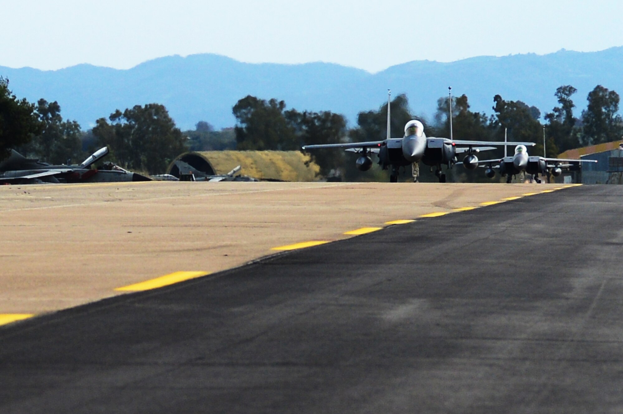 Two F-15E Strike Eagles assigned to the 492nd Fighter Squadron, Royal Air Force Lakenheath, England taxis at Andravida Air Base, Greece, March 21, 2018, during exercise INIOHOS 18. Thirteen 492nd Fighter Squadron F-15Es are participating in the Hellenic Air Force-led multinational exercise. (U.S. Air Force photo/1st Lt. Elias Small)