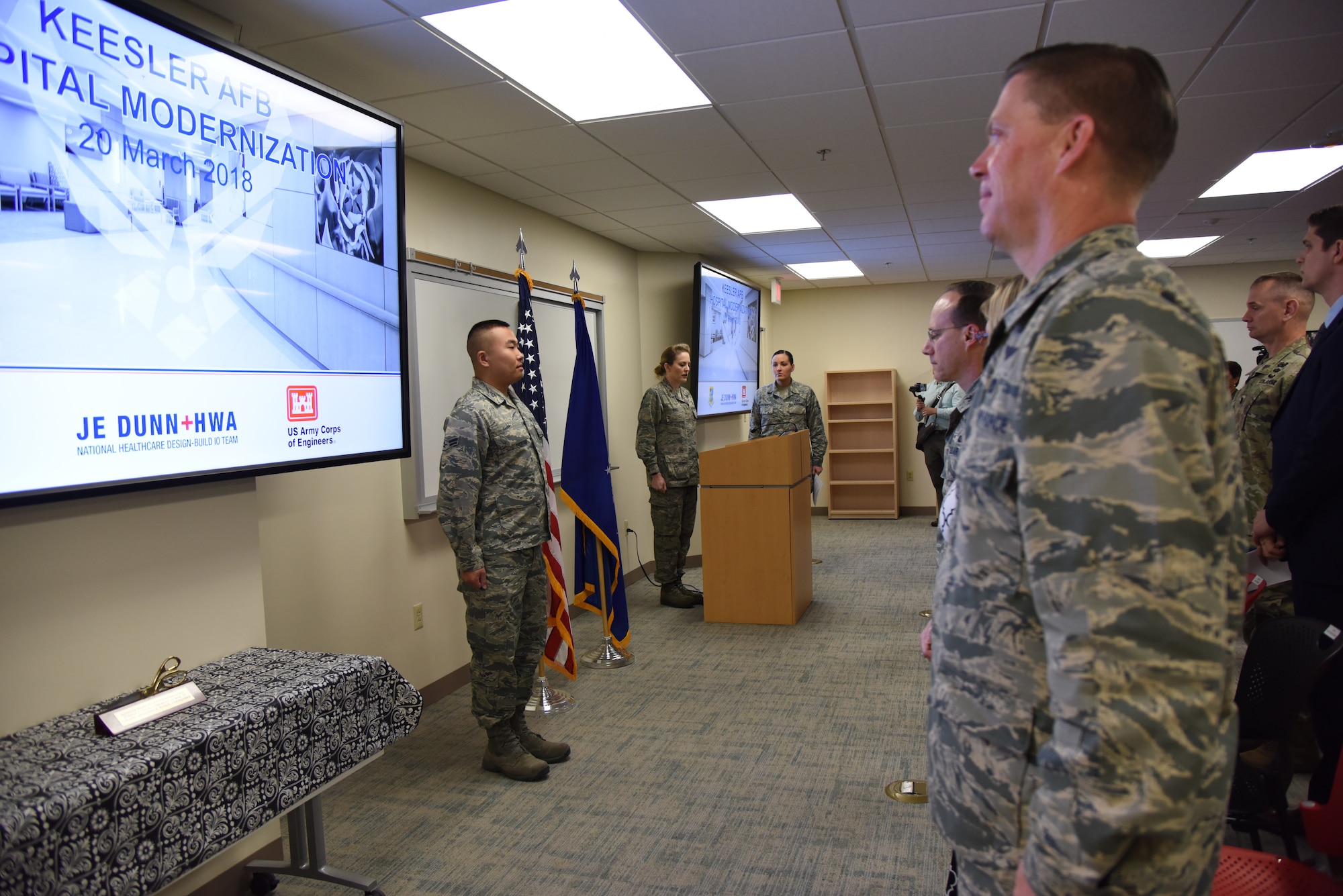 Keesler personnel stand at attention during the singing of the national anthem during the Keesler Medical Center renovations ribbon cutting ceremony March 20, 2018, on Keesler Air Force Base, Mississippi. The ceremony officially commemorated the completion of the $80 million renovations for the new dental and mental health clinics. The new renovations allow for improved patient support services. (U.S. Air Force photo by Kemberly Groue)