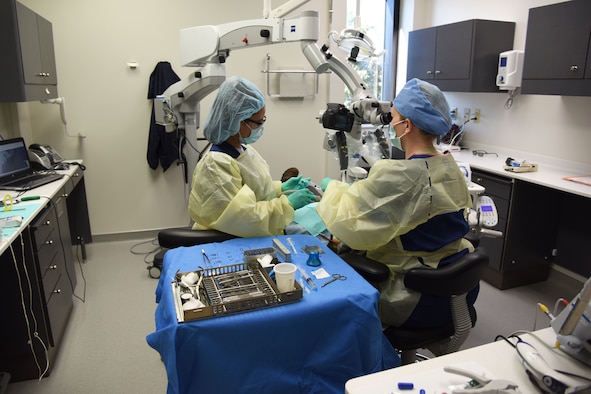 Hannah Garcia, 81st Dental Squadron dental assistant, and U.S. Air Force Maj. Kelley Hursh, 81st DS endodontic resident, tend to a patient inside the new dental clinic during the Keesler Medical Center renovations ribbon cutting ceremony March 20, 2018, on Keesler Air Force Base, Mississippi. The ceremony officially commemorated the completion of the $80 million renovations for the new dental and mental health clinics. The new renovations allow for improved patient support services. (U.S. Air Force photo by Kemberly Groue)