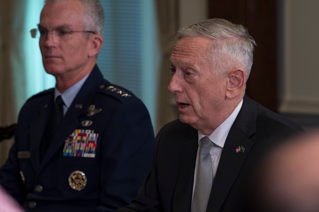Defense Secretary James N. Mattis, right, and Air Force Gen. Paul J. Selva, vice chairman of the Joint Chiefs of Staff, sit at a table.