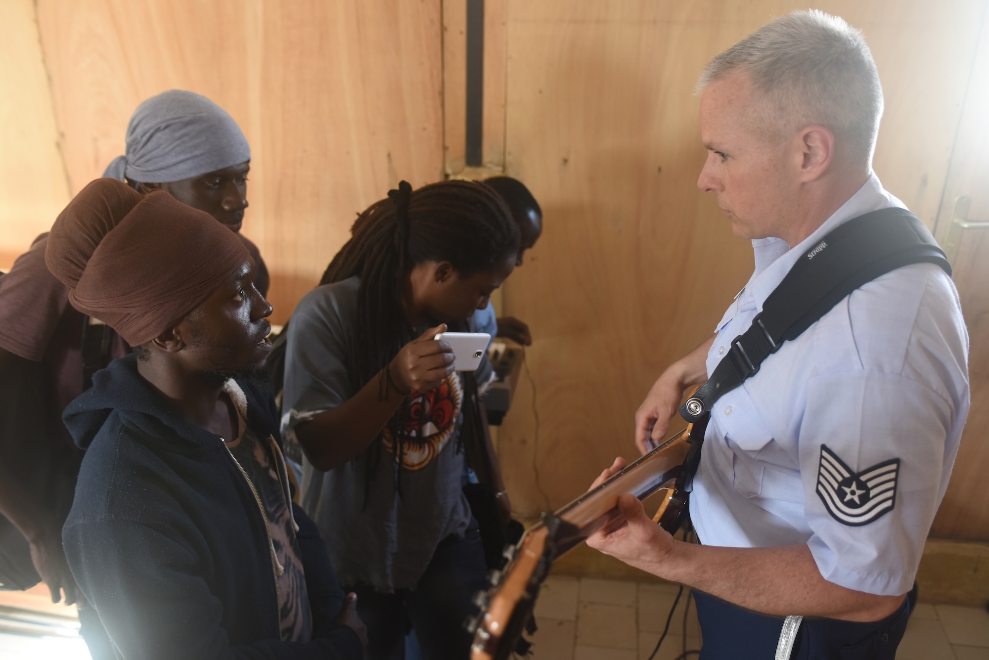 Tech. Sgt. Joseph Whitt teaches students bass guitar techniques at the National School of the Arts in Dakar, Senegal, March 21, 2018. The USAFE Band assists in building relationships through community engagement and outreach. (U.S. Air Force photo by Airman 1st Class Eli Chevalier)
