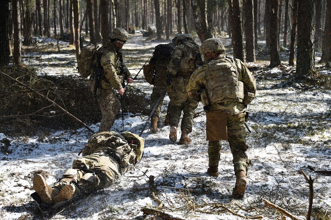Soldiers transport a mock casualty.