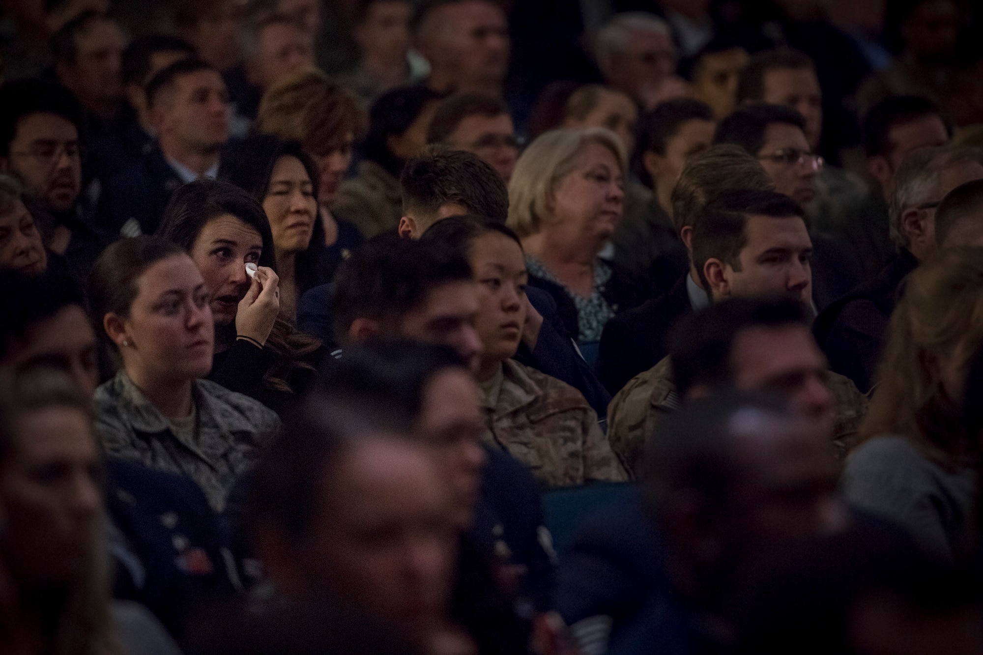 Guests watch a memorial service in honor of Capt. Mark Weber, March 21, 2018, at Moody Air Force Base, Ga. Weber, a 38th Rescue Squadron combat rescue officer and Texas native, was killed in an HH-60G Pave Hawk crash in Anbar Province, Iraq, March 15. During the ceremony, Weber was posthumously awarded a Meritorious Service Medal and the Air Force Commendation Medal. (U.S. Air Force photo by Staff Sgt. Ryan Callaghan)