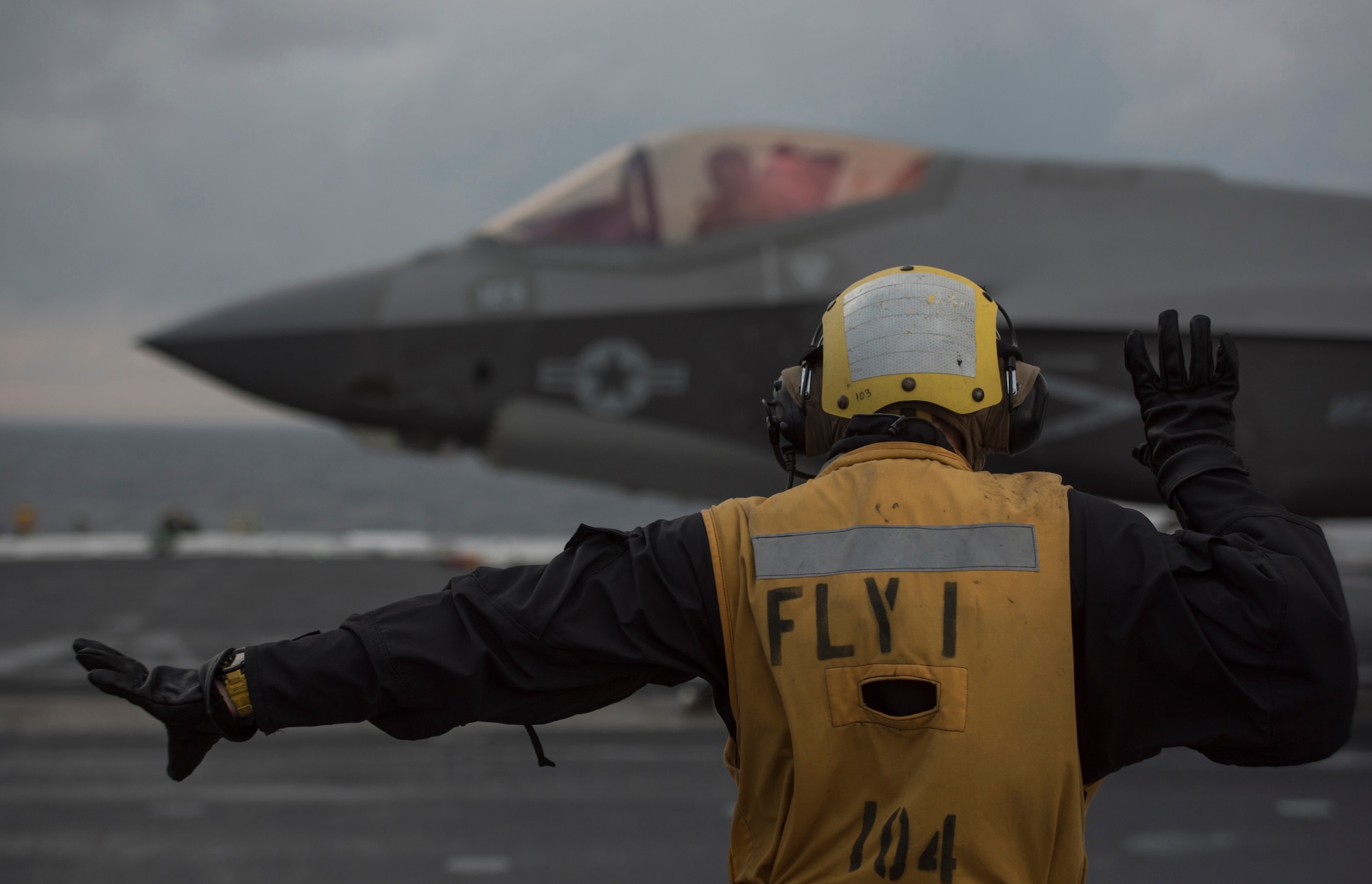 U.S. Navy Petty Officer First Class Antonio Rodriguez, Nimitz-Class aircraft carrier USS Abraham Lincoln (CVN-72) aviation boatswain's mate, directs an F-35C Lightning II assigned to Strike Fighter Squadron (VFA) 101 March 16, 2018, in the Altantic Ocean. (U.S. Air Force photo by Staff Sgt. Peter Thompson/Released)