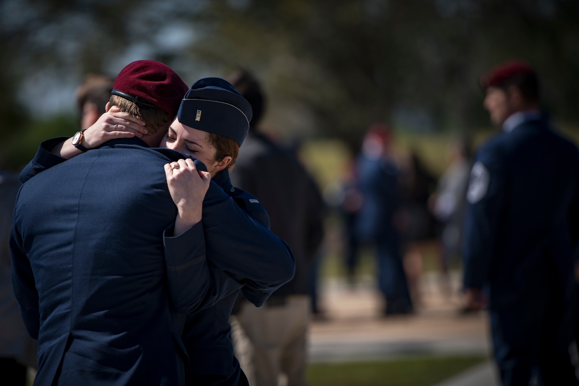 Airmen embrace following a memorial service in honor of Capt. Mark Weber, March 21, 2018, at Moody Air Force Base, Ga. Weber, a 38th Rescue Squadron combat rescue officer and Texas native, was killed in an HH-60G Pave Hawk crash in Anbar Province, Iraq, March 15. During the ceremony, Weber was posthumously awarded a Meritorious Service Medal and the Air Force Commendation Medal. (U.S. Air Force photo by Staff Sgt. Ryan Callaghan)