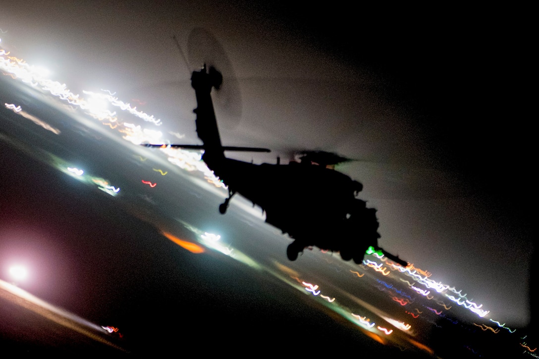 An Air Force helicopter crew conducts a training mission over Afghanistan at night.