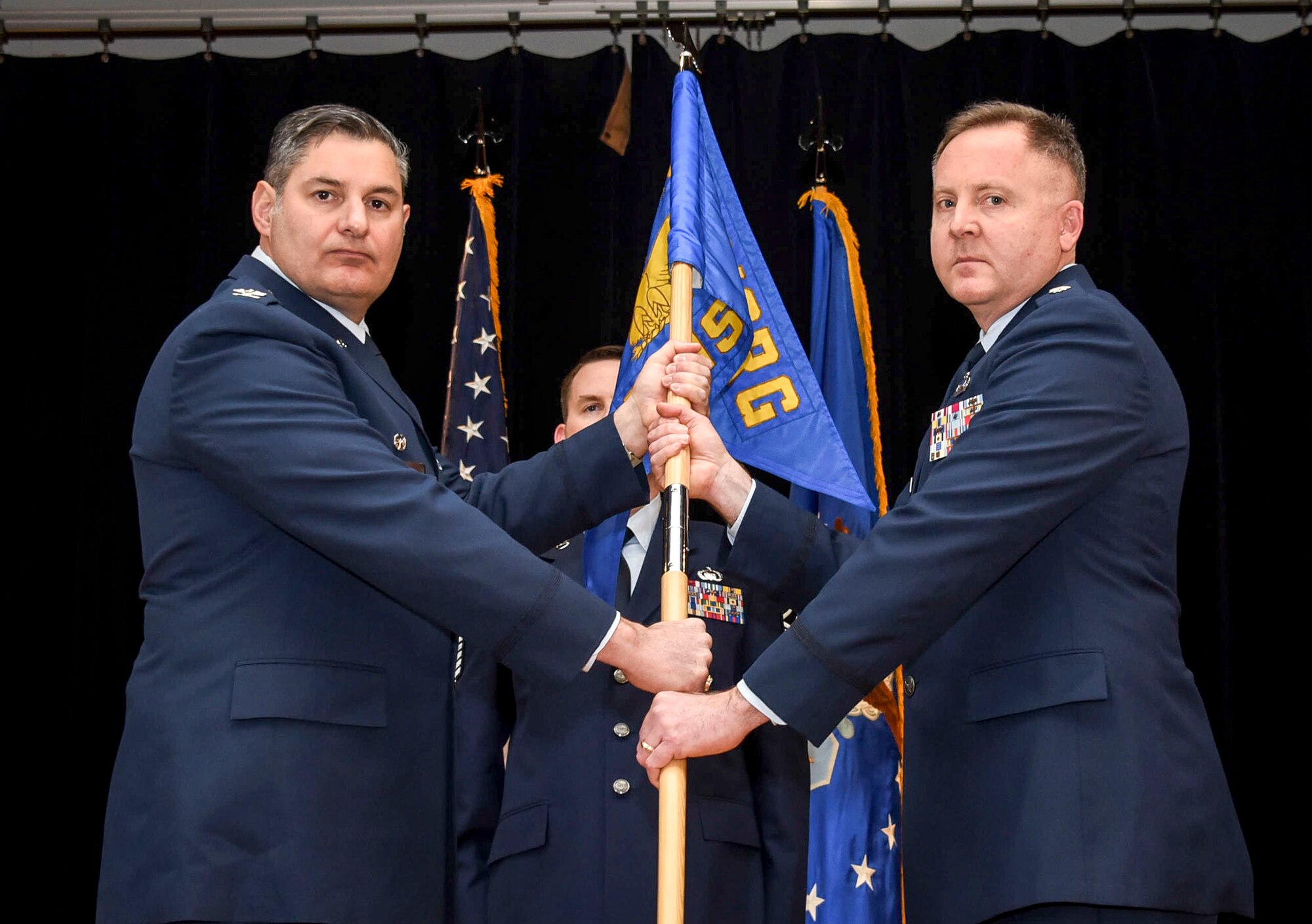 Col. John D. McKaye, 655th Intelligence, Surveillance and Reconnaissance Group commander, passes the guidon to Lt. Col. Jeffrey Derr, incoming 16th Intelligence Squadron commander, during a change of command ceremony March 10, 2018.