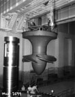 June 25, 1954 - Workers install hydroelectric turbine runner number 5 at McNary Lock and Dam, near Umatilla, Oregon.