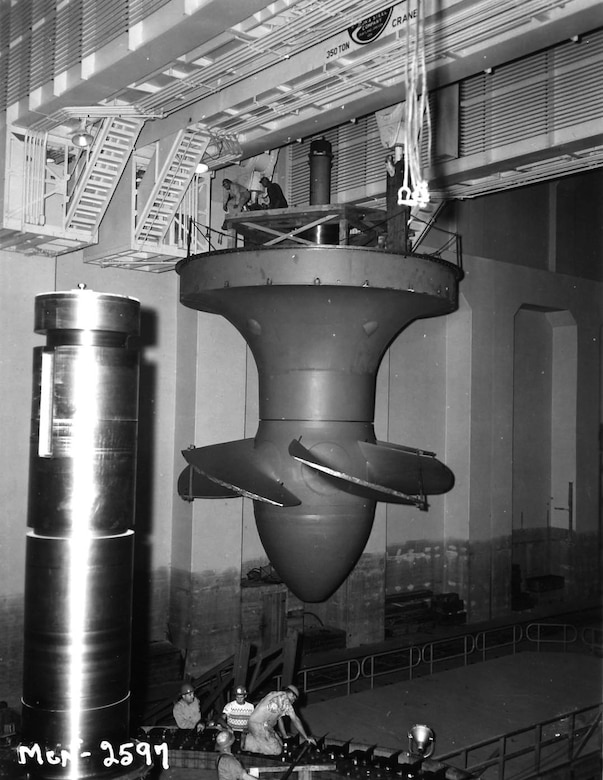June 25, 1954 - Workers install hydroelectric turbine runner number 5 at McNary Lock and Dam, near Umatilla, Oregon.