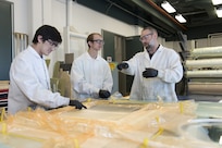 Johnny Ruffa, from the Ship Structures Branch at Naval Surface Warfare Center, Carderock Division, Will Ferrell, a doctoral student at University of Tennessee, Knoxville, and Dan Hart, an aerospace engineer from Carderock's Advanced Materials and Structures Branch, discuss the vacuum-assisted resin transfer molding (VARTM) process for additive manufacturing in the Composites Lab on March 15, 2018, at Carderock's West Bethesda, Md., headquarters.