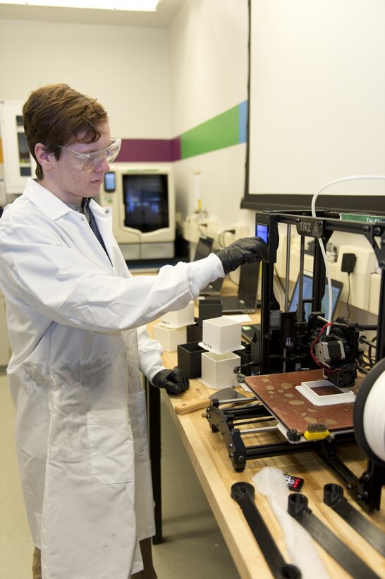 Will Buttrey, an undergraduate student from the University of Tennessee, Knoxville, prints materials using the polymer additive manufacturing (AM) printer March 15, 2018, in the Manufacturing, Knowledge and Education (MAKE) Lab at Naval Surface Warfare Center, Carderock Division in West Bethesda, Md. Buttrey is part of the Naval Engineering Education Consortium with Carderock researching AM material qualification and parts certification.