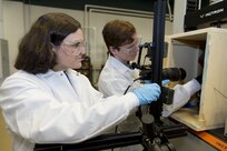Dr. Stephanie TerMaath (left), assistant professor at the University of Tennessee, Knoxville (UTK), and Will Buttrey, an undergraduate student at UTK, set up a system to perform mechanical testing inside an environmental chamber March 15, 2018, at Naval Surface Warfare Center, Carderock Division in West Bethesda, Md. TerMaath and Buttrey are part of the Naval Engineering Education Consortium with Carderock researching AM material qualification and parts certification