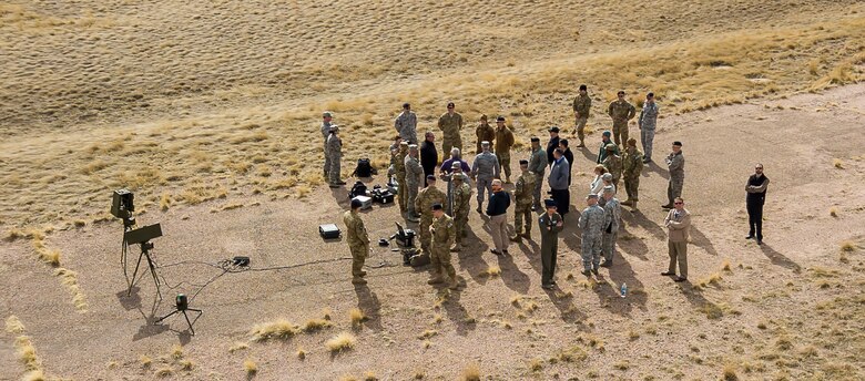 Attendees of the counter unmanned aerial systems Summit converse during a flight demonstration on F.E. Warren Air Force Base Wyo., March 14, 2018. The event allowed security forces Airmen from across Air Force Global Strike Command to cross-talk with each other and off-base civilians from seven federal agencies. (U.S. Air Force photo by Lieutenant Colonel Matt Pignataro)