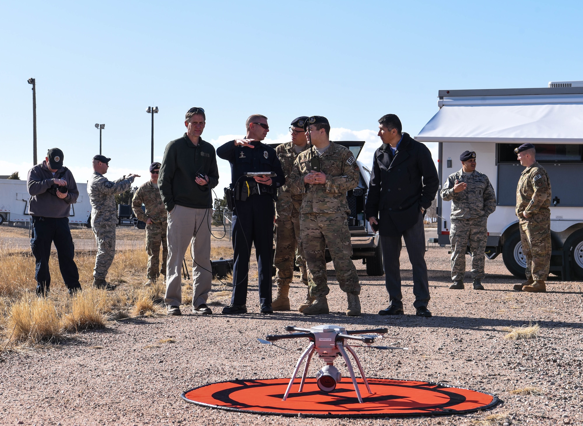 A group of Larimer County police officers converse with a security forces Airman during a flight demonstration at the counter unmanned aerial system Summit on F.E. Warren Air Force Base Wyo., March 13, 2018. Seven off-base federal agencies attended the event to cross-talk with security forces Airmen about their UAS programs. (U.S. Air Force photo by Airman 1st Class Braydon Williams)
