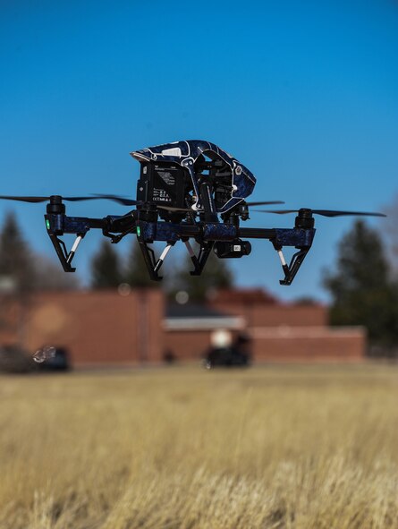 An unmanned aerial system hovers over the ground during a Larimer County flight demonstration at the CUAS Summit on F.E. Warren Air Force Base Wyo., March 13, 2018. Seven off-base federal agencies attended the event to cross-talk with security forces Airmen about their UAS programs. 
(U.S. Air Force photo by Airman 1st Class Braydon Williams)