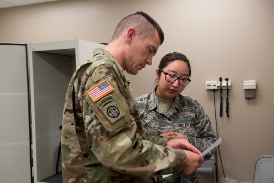 A patient asks U.S. Air Force Senior Airman Ashley Ko, 20th Aerospace Medicine Squadron public health technician, about his hearing test results at Shaw Air Force Base, S.C., March 20, 2018.