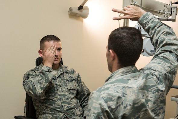 U.S. Air Force Staff Sgt. Stephen Spencer, 20th Aircraft Maintenance Squadron aerospace propulsion craftsman, covers his eye while Capt. John Kauderman, 20th Aerospace Medicine Squadron (AMDS) optometrist, tests his peripheral vision at Shaw Air Force Base, S.C., March 20, 2018.