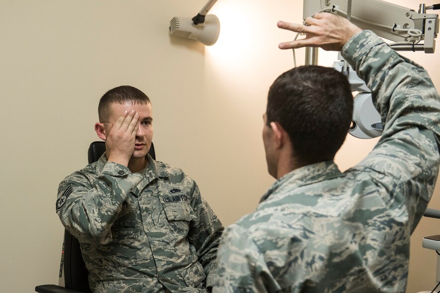 U.S. Air Force Staff Sgt. Stephen Spencer, 20th Aircraft Maintenance Squadron aerospace propulsion craftsman, covers his eye while Capt. John Kauderman, 20th Aerospace Medicine Squadron (AMDS) optometrist, tests his peripheral vision at Shaw Air Force Base, S.C., March 20, 2018.