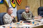 Chairman of Joint Chiefs of Staff and commander of NATO and U.S. forces in Afghanistan participate in a meeting.