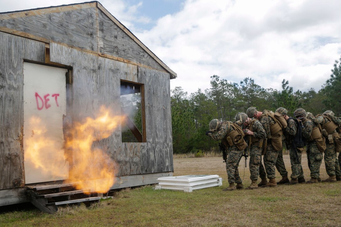 U.S. Marines from different units detonate a breaching charge during an urban breaching range at Camp Lejeune, N.C., March 20, 2018. Marines from both 2nd Combat Engineer Battalion and 3rd Battalion, 6th Marine Regiment, 2nd Marine Division conducted the training together to further improve proficiency in creating and using explosive breaching charges as well as improving unit cohesion.