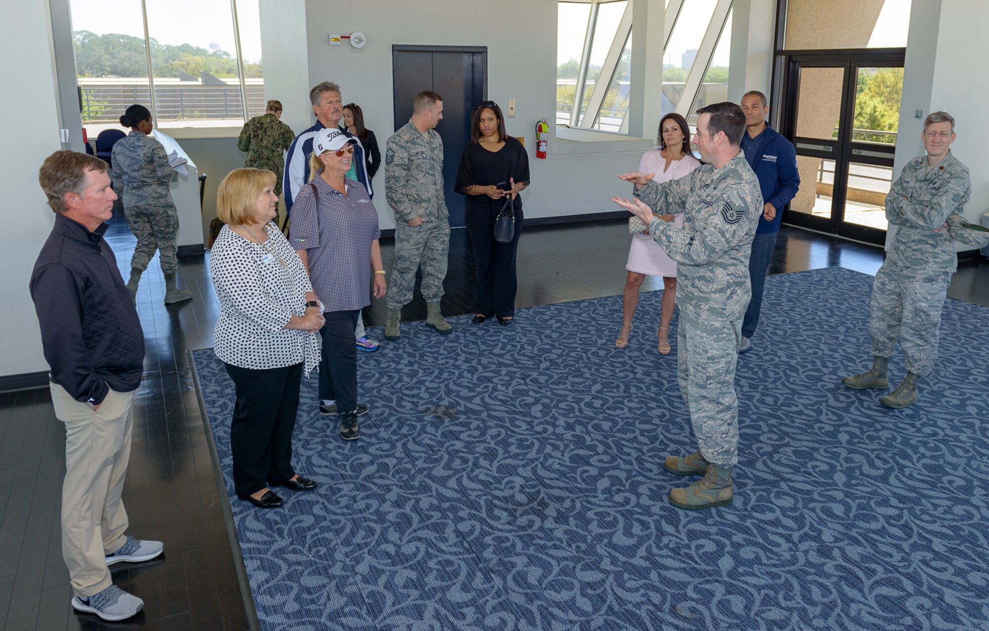 U.S. Air Force Tech. Sgt. Jacob Hail, 335th Training Squadron weather initial skills instructor, briefs the Professional Golf Association Tour champions and their wives during the Rapiscan System Golf Classic players’ tour March 20, 2018, on Keesler Air Force Base, Mississippi. The attending golfers who are participating in the 2018 Rapiscan System Golf Classic also toured the 53rd Weather Reconnaissance Squadron and the military working dog kennel. (U.S. Air Force photo by André Askew)