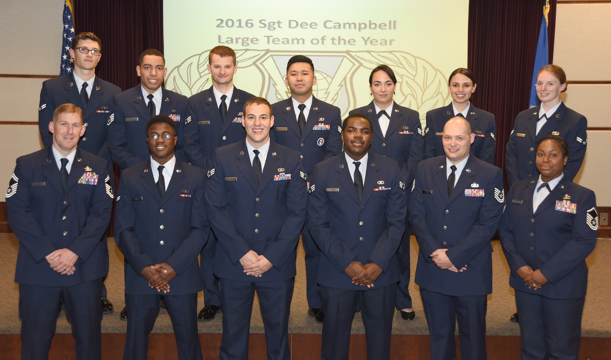 Master Sgt. Ieaka Olmstead, 22nd Operations Support Squadron host aviation resource management superintendent, poses for a photo with her flight during an award ceremony.