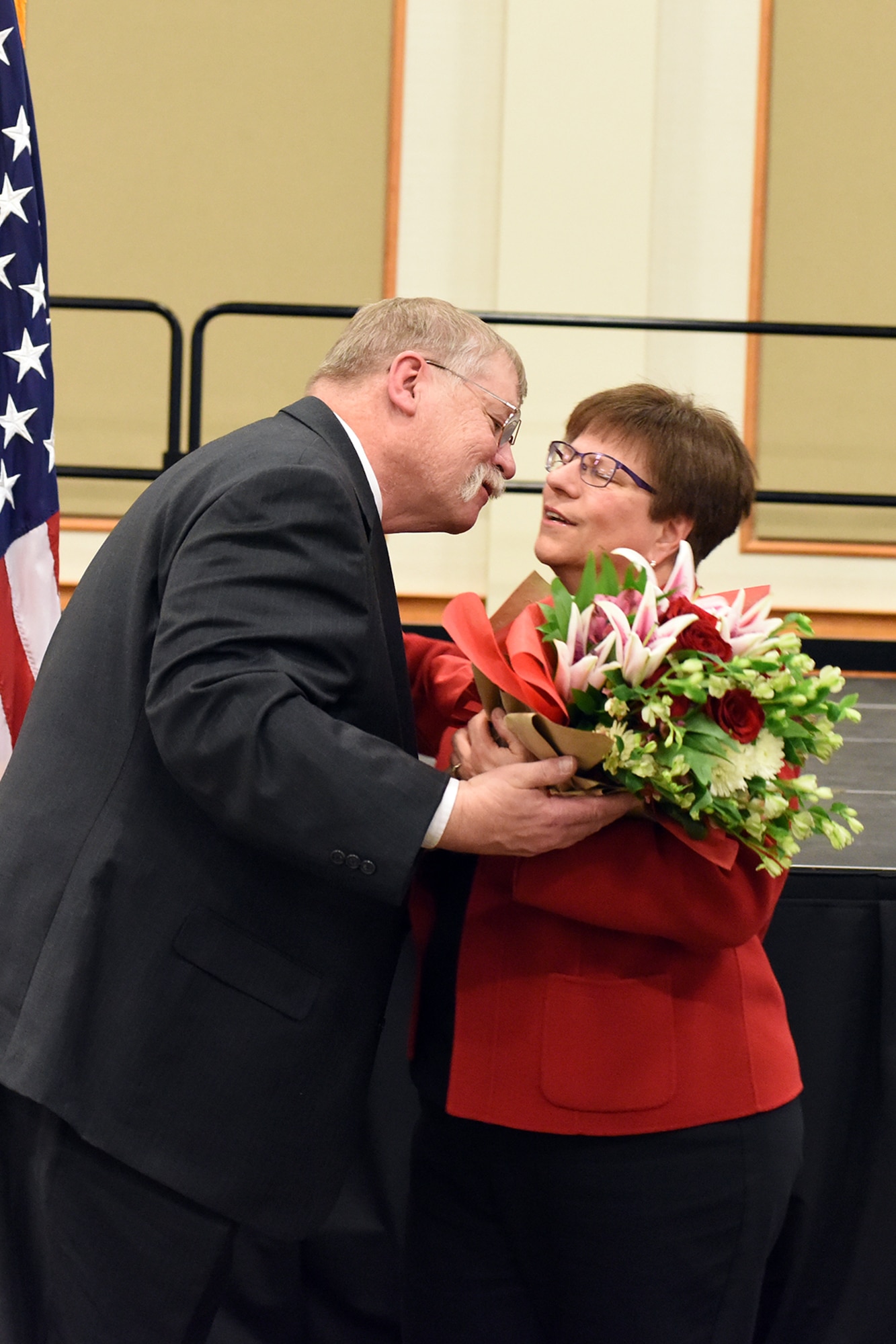 180228-F-UQ541-0665 Peter Woelkers Sr., 341st Missile Wing Weapons Safety Office chief of weapons safety/nuclear surety officer, embraces and thanks spouse Monica Woelkers, Feb. 28, 2018, at Malmstrom Air Force Base, Mont., during Peter Woelkers retirement ceremony. The couple has been married since 1975, and Monica has accompanied him through his 20-year civilian career at Malmstrom. (U.S. Air Force photo by Kiersten McCutchan)