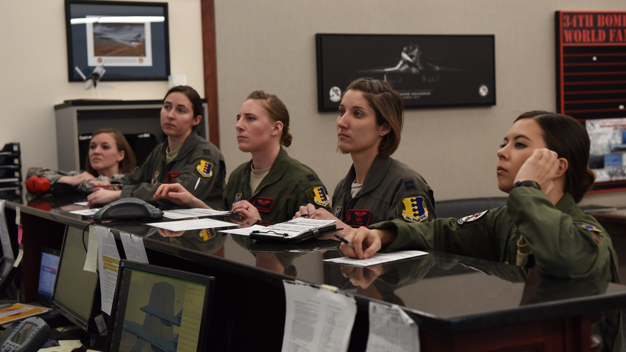 Capt. Lacey Koelling, the 34th Aircraft Maintenance Unit officer in charge, and 34th Bomb Squadron members Capt. Lillian Pryor, a B-1 pilot; Capt. Danielle Zidack, a weapon systems officer; Capt. Lauren Olme, a B-1 pilot; and 1st Lt. Kimberly Auton, a weapon systems officer, conduct a preflight briefing prior to an all-female flight out of Ellsworth Air Force Base, S.D., March 21, 2018. The flight was in honor of Women’s History Month and consisted of routine training in the local area. (U.S. Air Force photo by Staff Sgt. Jette Carr)