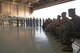 Luke's command team, friends and family of both pilots, bear witness to the 425th Fighter Squadron's change of command ceremony while members of the squadron stand in formation to honor their old and new commanders at Luke Air Force Base, Ariz. March 16, 2018. Lt. Col. Mark Whisler assumed command from Lt. Col. Jason Cooper. (U.S. Air Force photo/Senior Airman Ridge Shan)