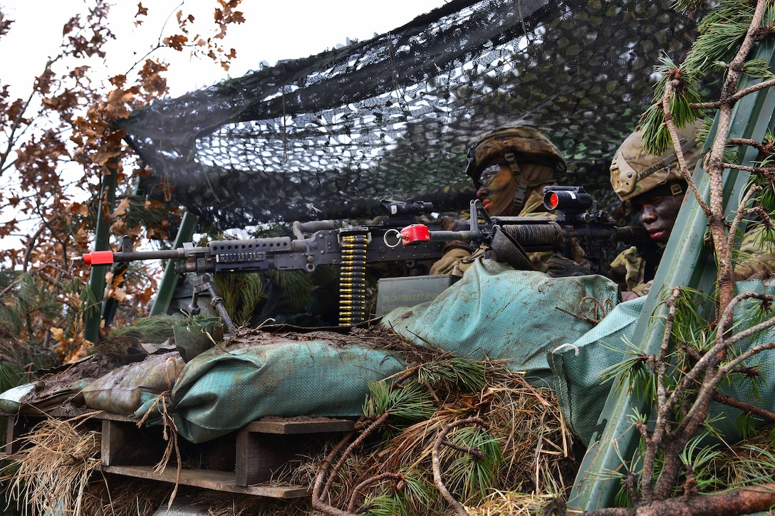 Soldiers scan their sector providing security.