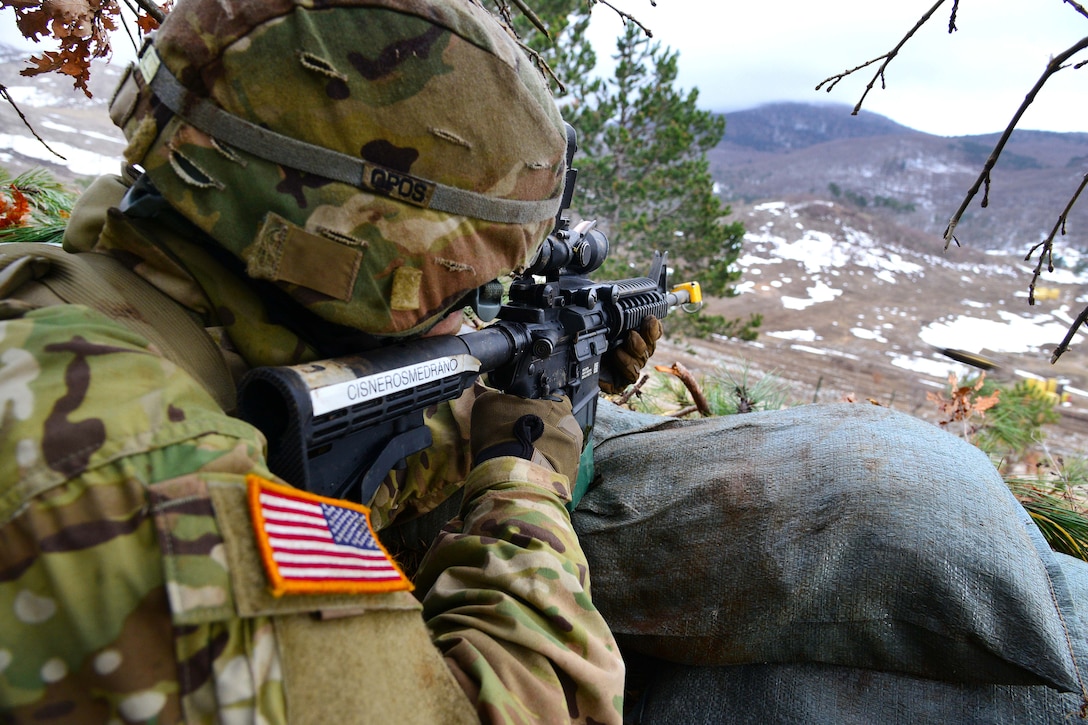 A soldier fires a M4 carbine.