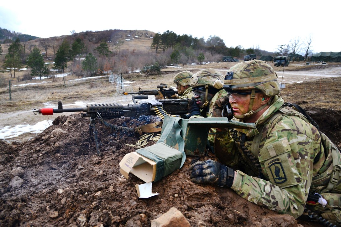 A soldier uses a field radio.