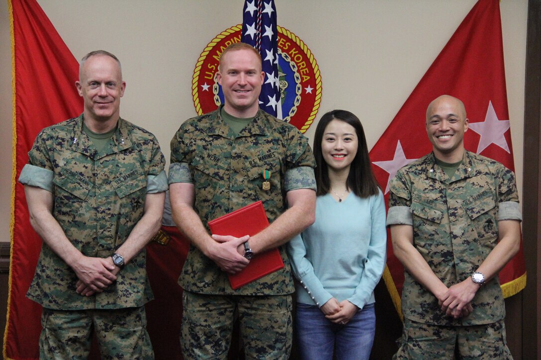 Staff Sgt. Bradley A. Wenk (center), network operations chief with U.S. Marine Corps Forces Korea, stands alongside  Maj. Gen. Patrick J. Hermesmann (left), MARFORK commander, and Lt. Col. Cedric N. Lee, assistant chief of staff of Communications for MARFORK,  following an award ceremony here, March 22.  Wenk was awarded the Navy and Marine Corps Achievement Medal for performance as the Networking Operations Chief. (Official U.S. Marine Corps Photo by Sgt. Nathaniel Hanscom/Released)