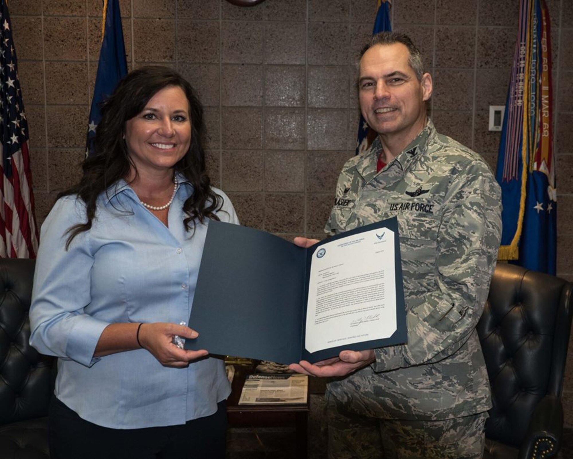 Col. Tony Polashek, 934th Airlift Wing commander, presents Kelly Chafe, Delta airlines administrative assistant, with a letter of appreciation for her transportation support for Medal of Honor recipients during Super Bowl LII week. Ms. Chafe provided 934th members with continuing updates of gate changes, personally escorted MOH recipients from aircraft and facilitated the use of restricted areas by 934th transportation personnel. Her efforts allowed 934th transportation members to pick up MOH recipients at induvidual aircraft and greatly reduce transportation time to their destination. (Air Force Photo/Paul Zadach)