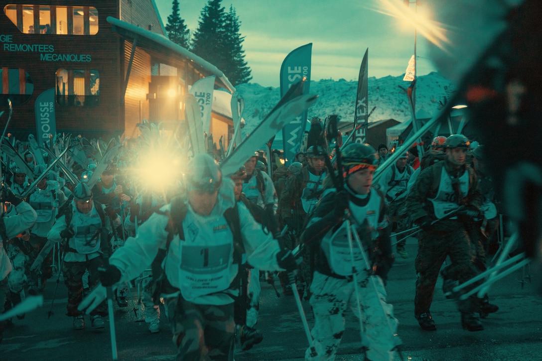 Competitors, including Marines from the Mountain Leaders Section, Mountain Warfare Training Center, Bridgeport, Calif., move from the start of the main touring event at the Mountain Troops Winter Challenge 2018, Chamrousse, France, March 14, 2018. "Team America" is one of six international teams participating in the competition of mountain infantry skills and tactics. (U.S. Marine Corps photo by Lance Cpl. Preston L. Morris)