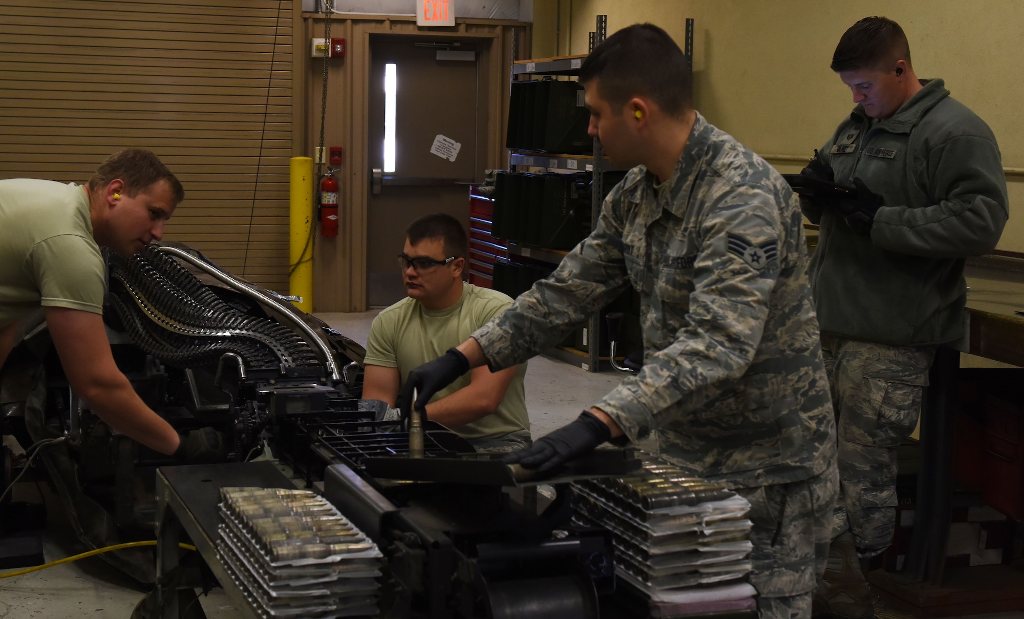 U.S. Airmen from the 20th Equipment Maintenance Squadron (EMS) work together to process and download 20 mm rounds at Shaw Air Force Base, S.C., March 14, 2018.