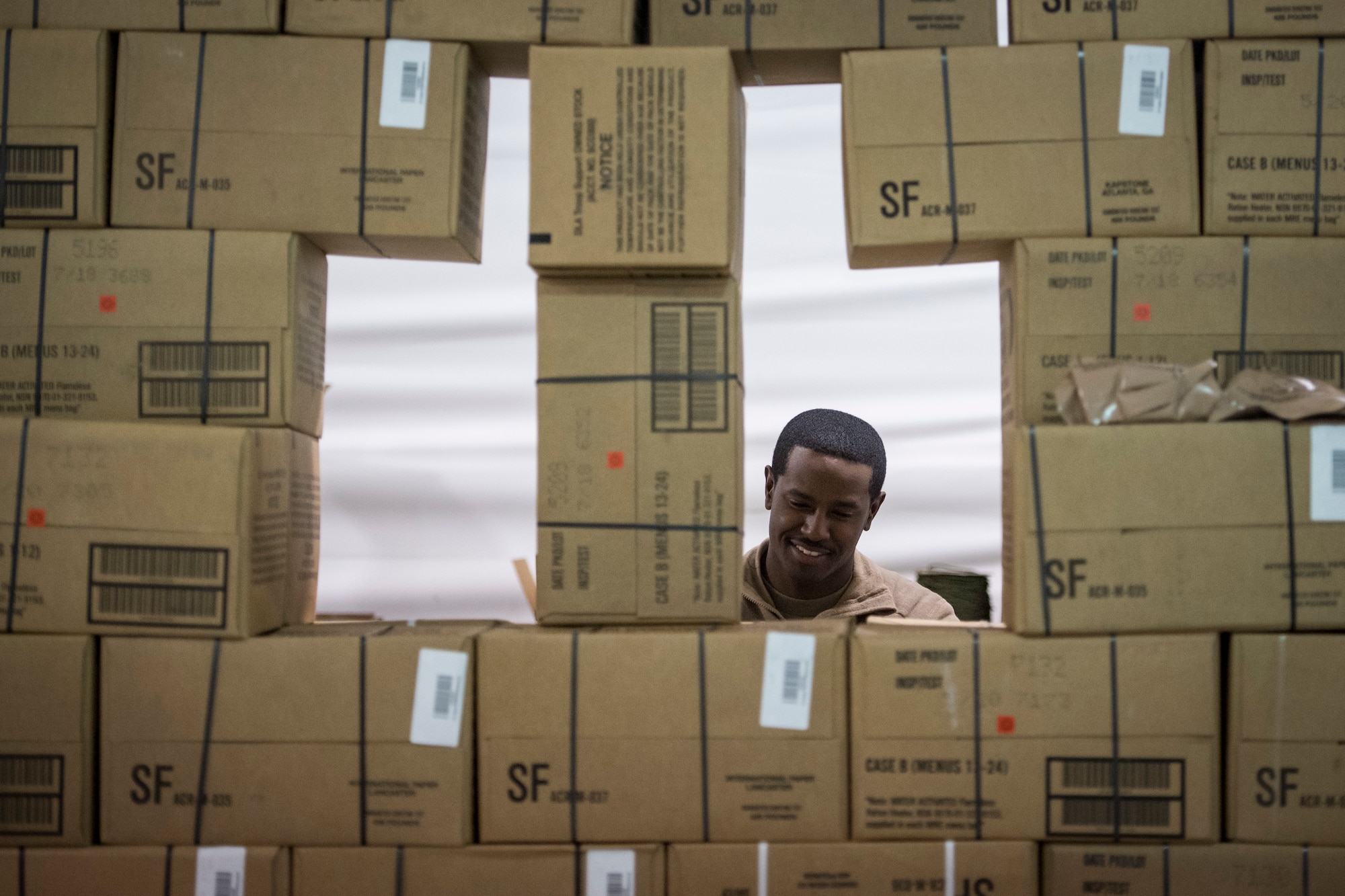 Staff Sgt. Terrell Perryman, 824th Base Defense Squadron supply liaison, laughs while taking inventory during a Mission Readiness Exercise, March 13, 2018, at Joint Base McGuire-Dix Lakehurst, N.J. Evaluators tested the 824th BDS from Moody Air Force Base, Ga., and the 105th Security Forces Squadron from Stewart Air National Guard Base, N.Y., to ensure their combat readiness. (U.S. Air Force photo by Senior Airman Janiqua P. Robinson)